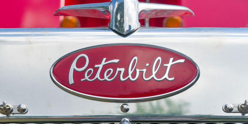 A Peterbilt emblem on a grill of a semi-truck